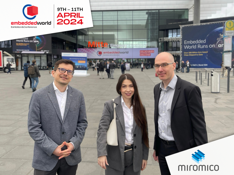 photo of three people outside convention center at embedded world 2024